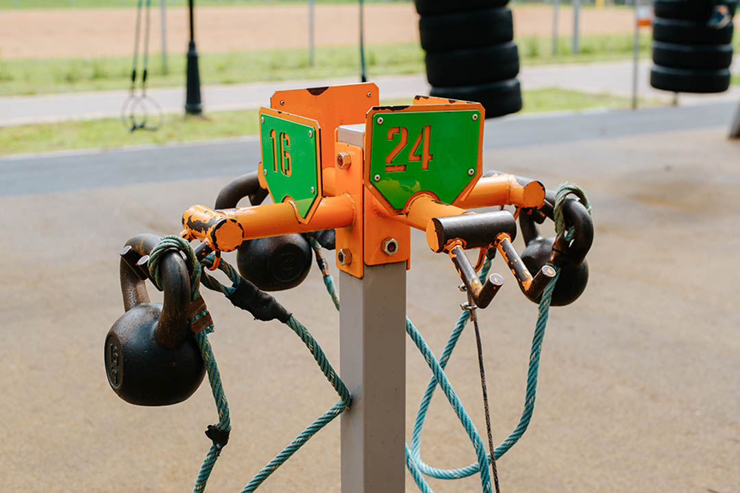 Set of kettlebells for weightlifting training on sports ground in park, outdoors. Workout and bodybuilding concept